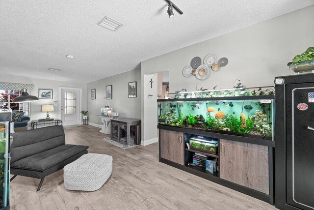 639 Mallard Dr, Delray Beach, FL 33444 - living area featuring a textured ceiling and wood finished floors