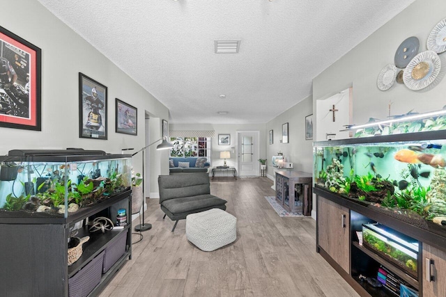 639 Mallard Dr, Delray Beach, FL 33444 - living area with a textured ceiling and light wood finished floors