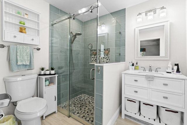 639 Mallard Dr, Delray Beach, FL 33444 - bathroom featuring a stall shower, toilet, vanity, and wood finished floors