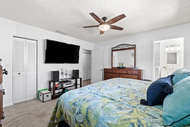 639 Mallard Dr, Delray Beach, FL 33444 - carpeted bedroom featuring multiple closets, a textured ceiling, a ceiling fan, and ensuite bath