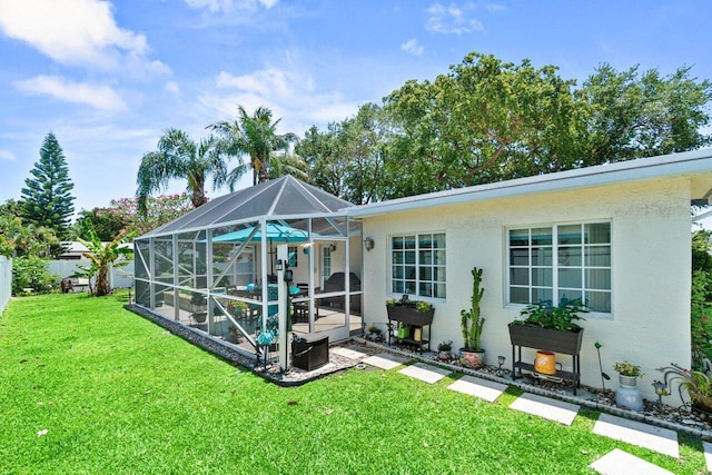 639 Mallard Dr, Delray Beach, FL 33444 - back of house featuring a yard, a patio, glass enclosure, stucco siding, and a pool