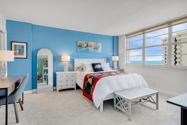 2121 N Ocean Blvd Unit 1203W, Boca Raton, FL 33431 - bedroom featuring baseboards, carpet, and arched walkways