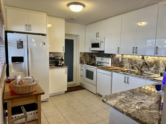 728 Ridge Rd Unit 35, Lantana, FL 33462 - kitchen featuring white appliances, a sink, light tile patterned flooring, backsplash, and white cabinetry
