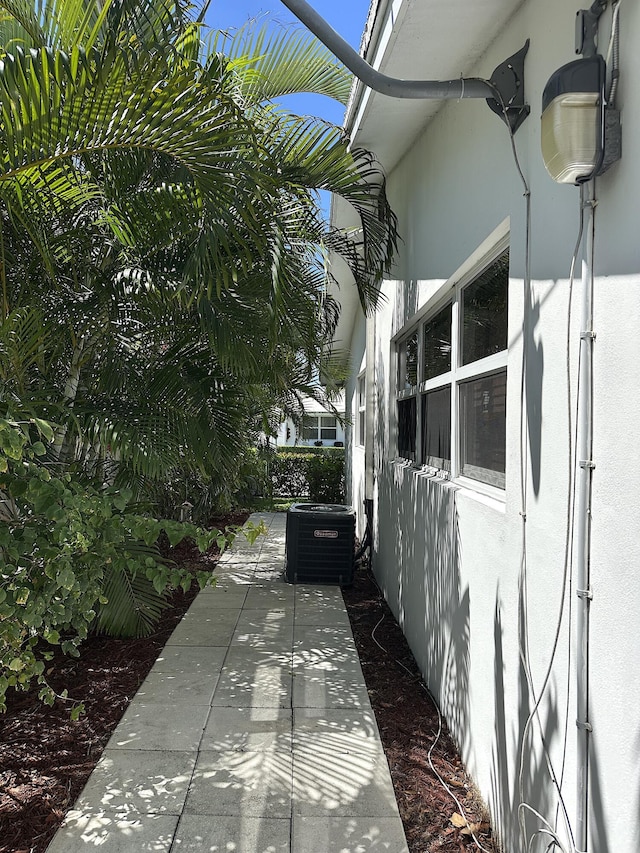 728 Ridge Rd Unit 35, Lantana, FL 33462 - view of side of property featuring central AC unit and stucco siding