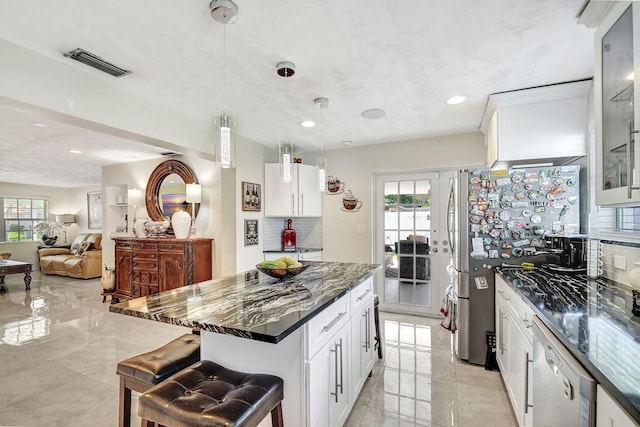 kitchen with dishwasher, tasteful backsplash, white cabinets, and recessed lighting