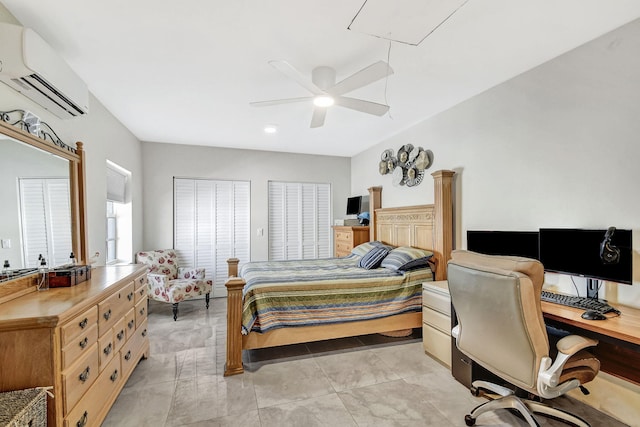 bedroom with an AC wall unit, an office area, attic access, and ceiling fan