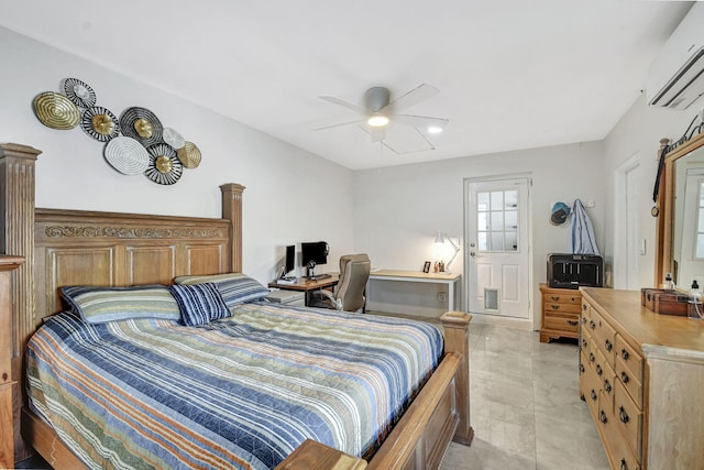 bedroom with a wall mounted air conditioner, an office area, and a ceiling fan