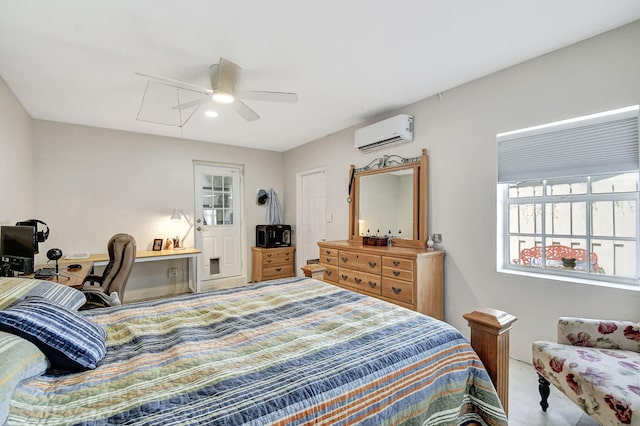 bedroom with attic access, an AC wall unit, an office area, ceiling fan, and carpet