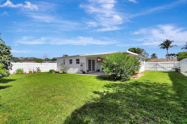 rear view of property with french doors, a patio area, and stucco siding