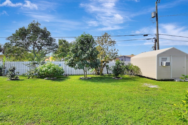 view of yard featuring a storage unit, an outbuilding, and cooling unit