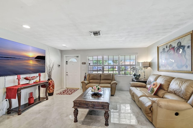 living area with recessed lighting and marble finish flooring