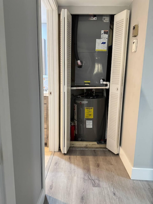 utility room featuring water heater