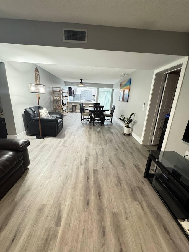 living area featuring wood finished floors and baseboards