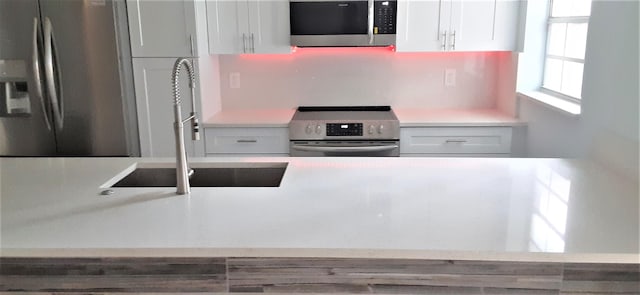 14516 Canalview Dr Unit B, Delray Beach, FL 33484 - kitchen with appliances with stainless steel finishes, white cabinets, and light countertops