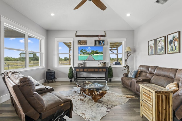 1545 Pulitzer Rd, Fort Pierce, FL 34945 - living room featuring a wood stove, ceiling fan, recessed lighting, baseboards, and wood finished floors