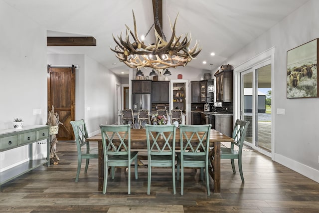 1545 Pulitzer Rd, Fort Pierce, FL 34945 - dining space with a chandelier, a barn door, baseboards, dark wood-style floors, and lofted ceiling