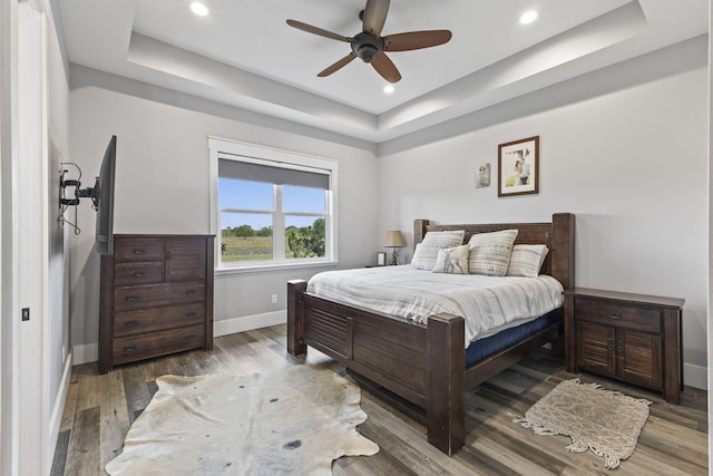 1545 Pulitzer Rd, Fort Pierce, FL 34945 - bedroom featuring a tray ceiling, baseboards, wood finished floors, recessed lighting, and ceiling fan