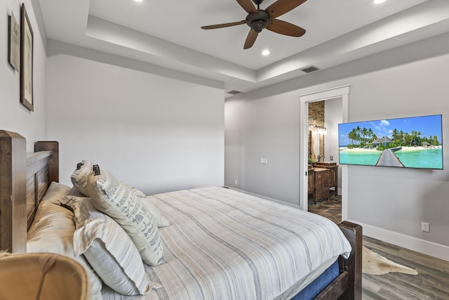1545 Pulitzer Rd, Fort Pierce, FL 34945 - bedroom featuring baseboards, recessed lighting, wood finished floors, a tray ceiling, and a ceiling fan