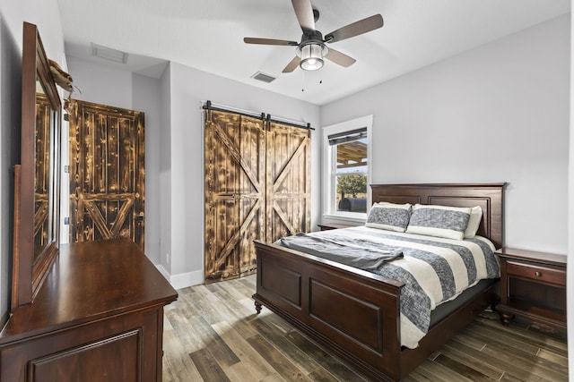 1545 Pulitzer Rd, Fort Pierce, FL 34945 - bedroom featuring wood finished floors, a barn door, and a ceiling fan