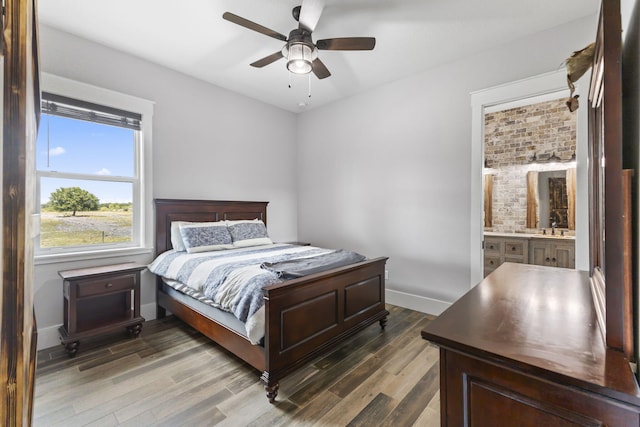 1545 Pulitzer Rd, Fort Pierce, FL 34945 - bedroom featuring wood finished floors, baseboards, connected bathroom, and ceiling fan
