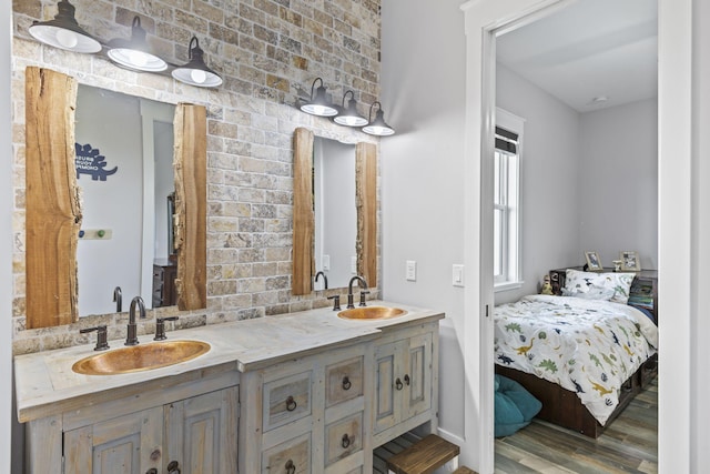 1545 Pulitzer Rd, Fort Pierce, FL 34945 - ensuite bathroom featuring wood finished floors, double vanity, and baseboards