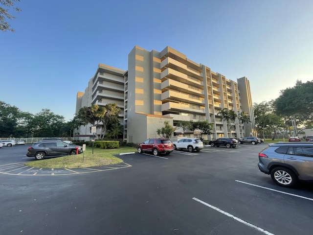view of building exterior with uncovered parking