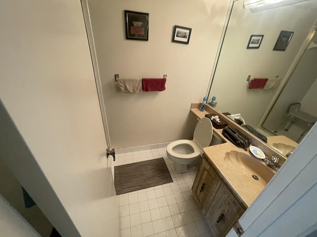 bathroom featuring tile patterned floors, toilet, and vanity