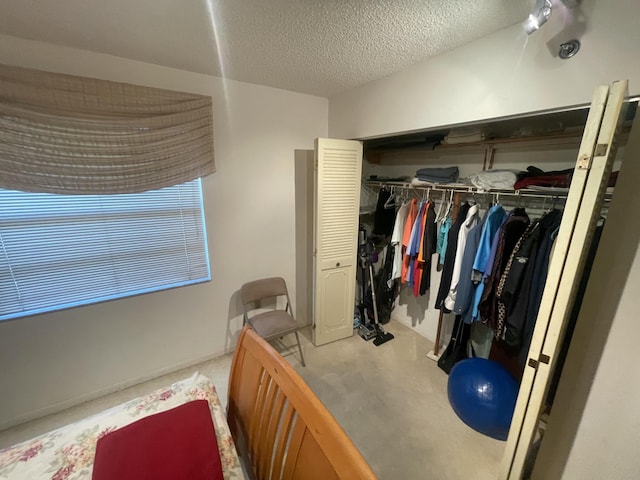 carpeted bedroom featuring a closet and a textured ceiling