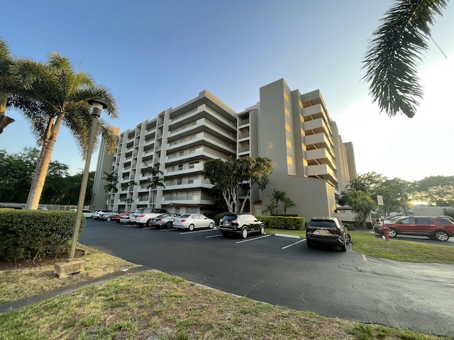 view of apartment building / complex featuring uncovered parking