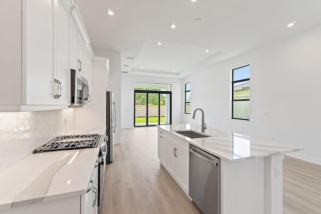 308 SE Via Sangro, Port Saint Lucie, FL 34987 - kitchen featuring stainless steel appliances, a sink, light wood-style floors, white cabinets, and recessed lighting