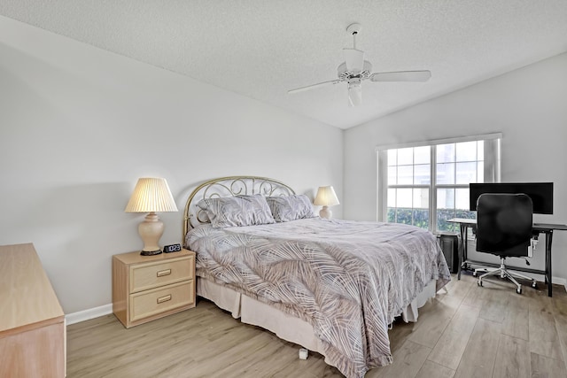 1265 Pine Sage Cir, West Palm Beach, FL 33409 - bedroom featuring light wood-style flooring, vaulted ceiling, a textured ceiling, ceiling fan, and a desk
