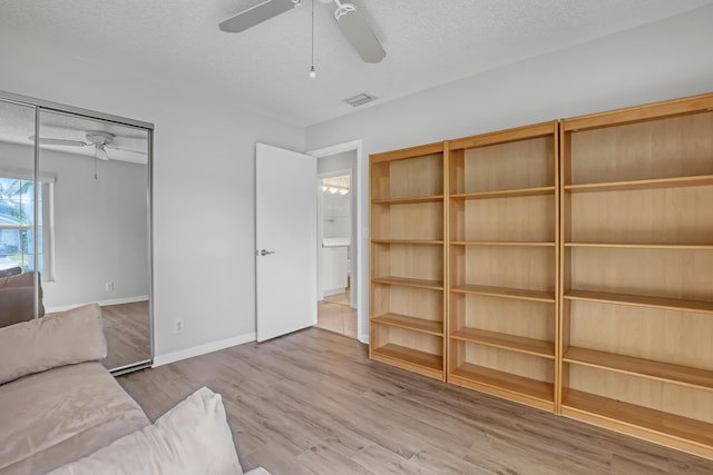 1265 Pine Sage Cir, West Palm Beach, FL 33409 - unfurnished living room with ceiling fan, a textured ceiling, and wood finished floors