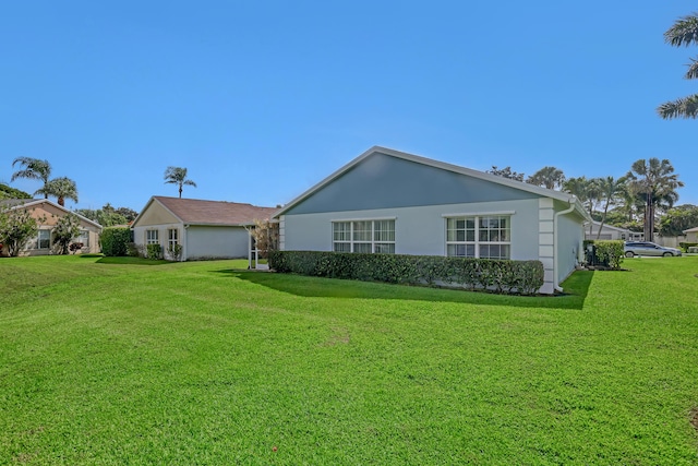 1265 Pine Sage Cir, West Palm Beach, FL 33409 - rear view of house featuring a yard and stucco siding