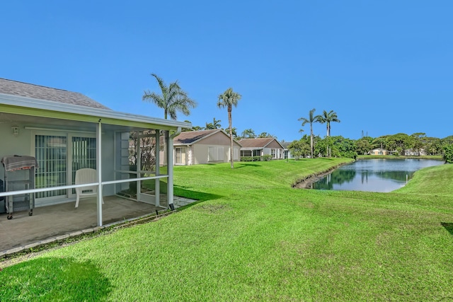 1265 Pine Sage Cir, West Palm Beach, FL 33409 - view of green lawn featuring a water view, a sunroom, and a patio area