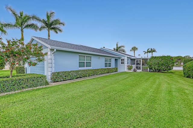 1265 Pine Sage Cir, West Palm Beach, FL 33409 - back of property with an attached garage, a yard, stucco siding, and a shingled roof