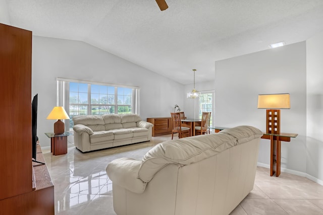 1265 Pine Sage Cir, West Palm Beach, FL 33409 - living room with vaulted ceiling, light tile patterned floors, a chandelier, a ceiling fan, and a textured ceiling