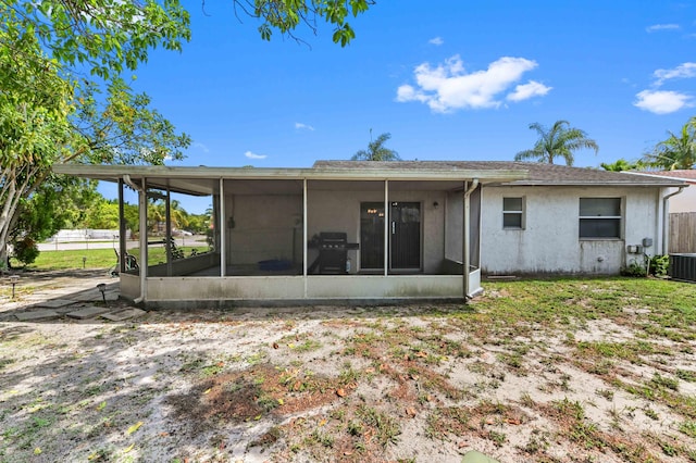 4755 Centurian Way, Greenacres, FL 33463 - rear view of property featuring a sunroom, stucco siding, fence, and cooling unit