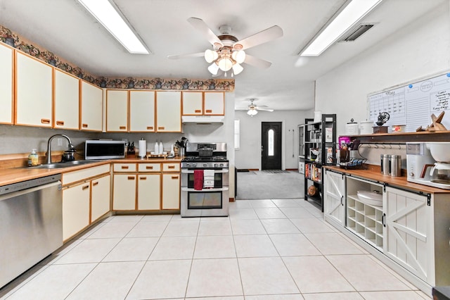 4755 Centurian Way, Greenacres, FL 33463 - kitchen featuring appliances with stainless steel finishes, a sink, ceiling fan, under cabinet range hood, and light tile patterned floors