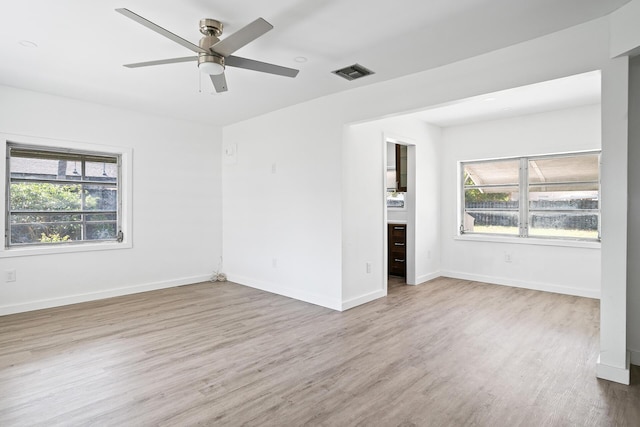 604 W Ocean Ave, Lantana, FL 33462 - empty room featuring healthy amount of natural light, wood finished floors, ceiling fan, and baseboards