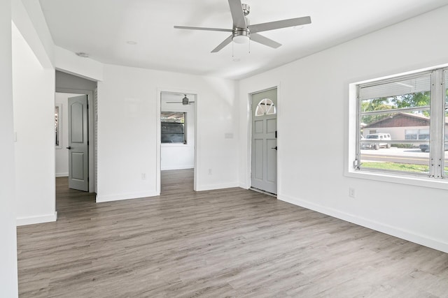 604 W Ocean Ave, Lantana, FL 33462 - unfurnished living room featuring ceiling fan, wood finished floors, and baseboards