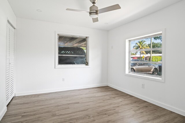 604 W Ocean Ave, Lantana, FL 33462 - unfurnished bedroom featuring wood finished floors, baseboards, and a ceiling fan
