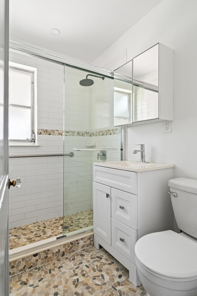 604 W Ocean Ave, Lantana, FL 33462 - full bath featuring toilet, a stall shower, vanity, and stone finish flooring