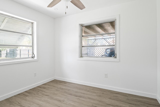 604 W Ocean Ave, Lantana, FL 33462 - spare room featuring plenty of natural light, ceiling fan, wood finished floors, and baseboards
