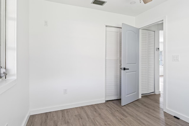 604 W Ocean Ave, Lantana, FL 33462 - unfurnished bedroom with wood finished floors, baseboards, and a closet
