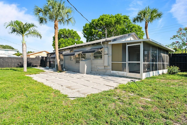 604 W Ocean Ave, Lantana, FL 33462 - rear view of property with a sunroom and a patio area