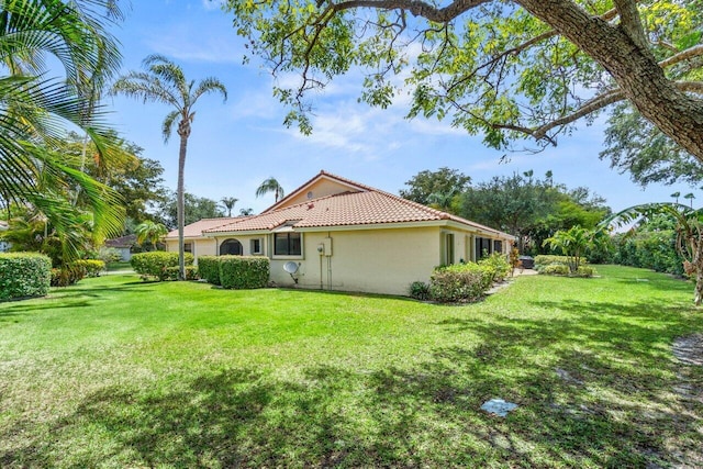10535 Ladypalm Ln Unit B, Boca Raton, FL 33498 - back of house featuring stucco siding, a tile roof, and a yard