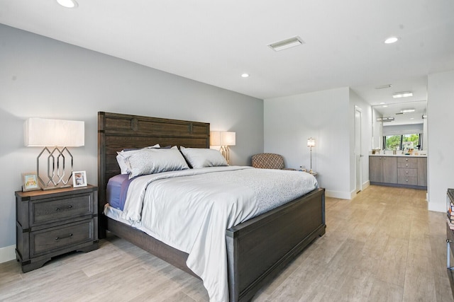 21188 Juego Cir Unit 17-A, Boca Raton, FL 33433 - bedroom with light wood-style floors, recessed lighting, baseboards, and ensuite bath