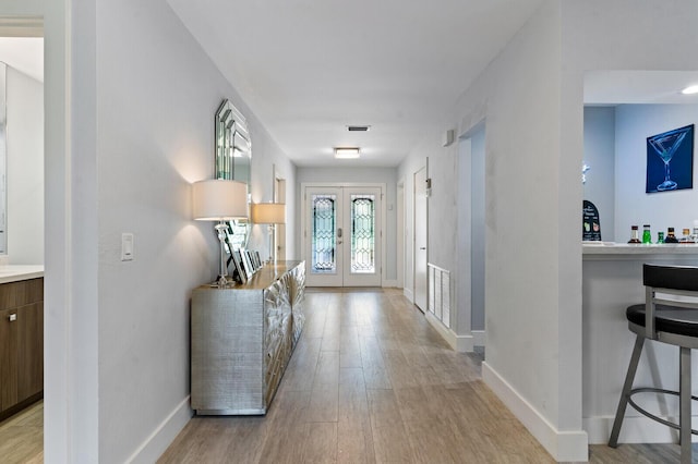 21188 Juego Cir Unit 17-A, Boca Raton, FL 33433 - foyer entrance featuring french doors, light wood-style flooring, and baseboards