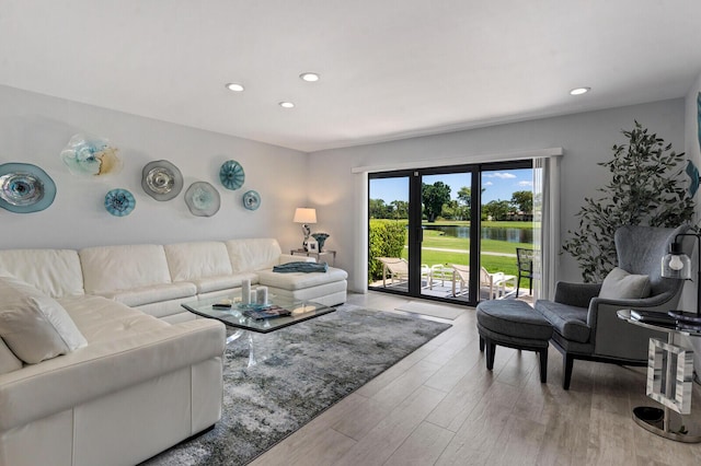 21188 Juego Cir Unit 17-A, Boca Raton, FL 33433 - living area with light wood-style flooring, recessed lighting, and a water view