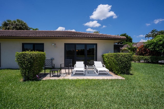 21188 Juego Cir Unit 17-A, Boca Raton, FL 33433 - back of house with stucco siding, a yard, a tile roof, and a patio area
